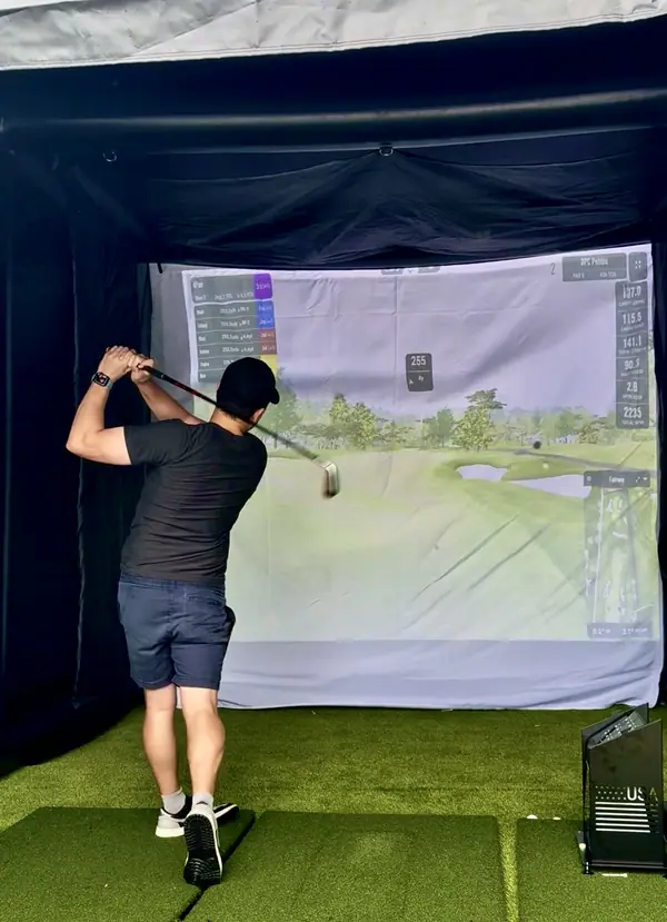 A guest following through on a shot inside the bay